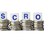 Stacks of coins with the word ESCROW isolated on white background